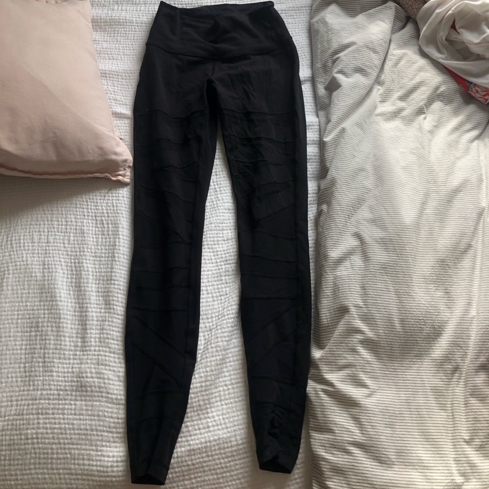 Black Lululemon leggings with mesh cutouts
